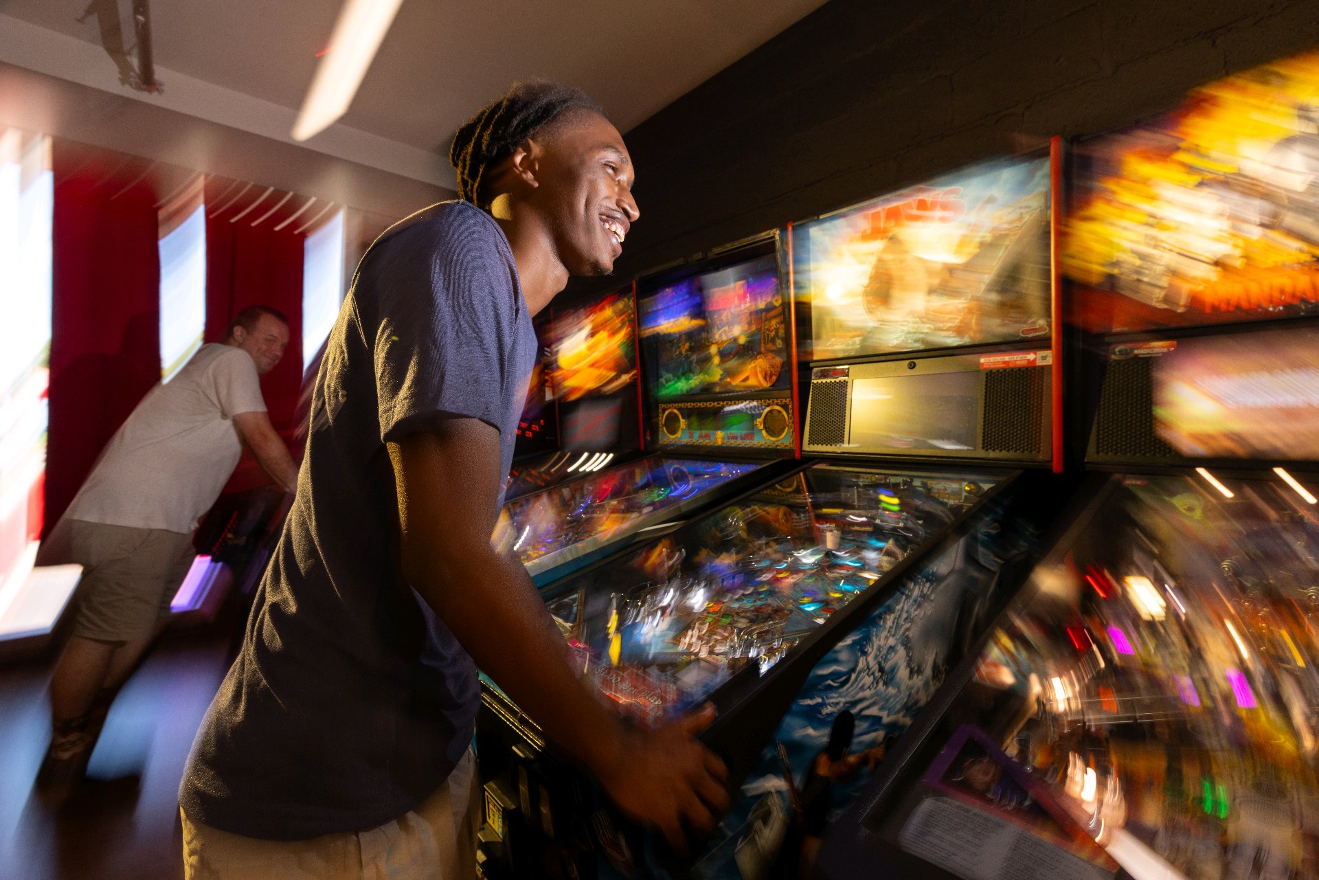 A guest playing pinball in the brewery
