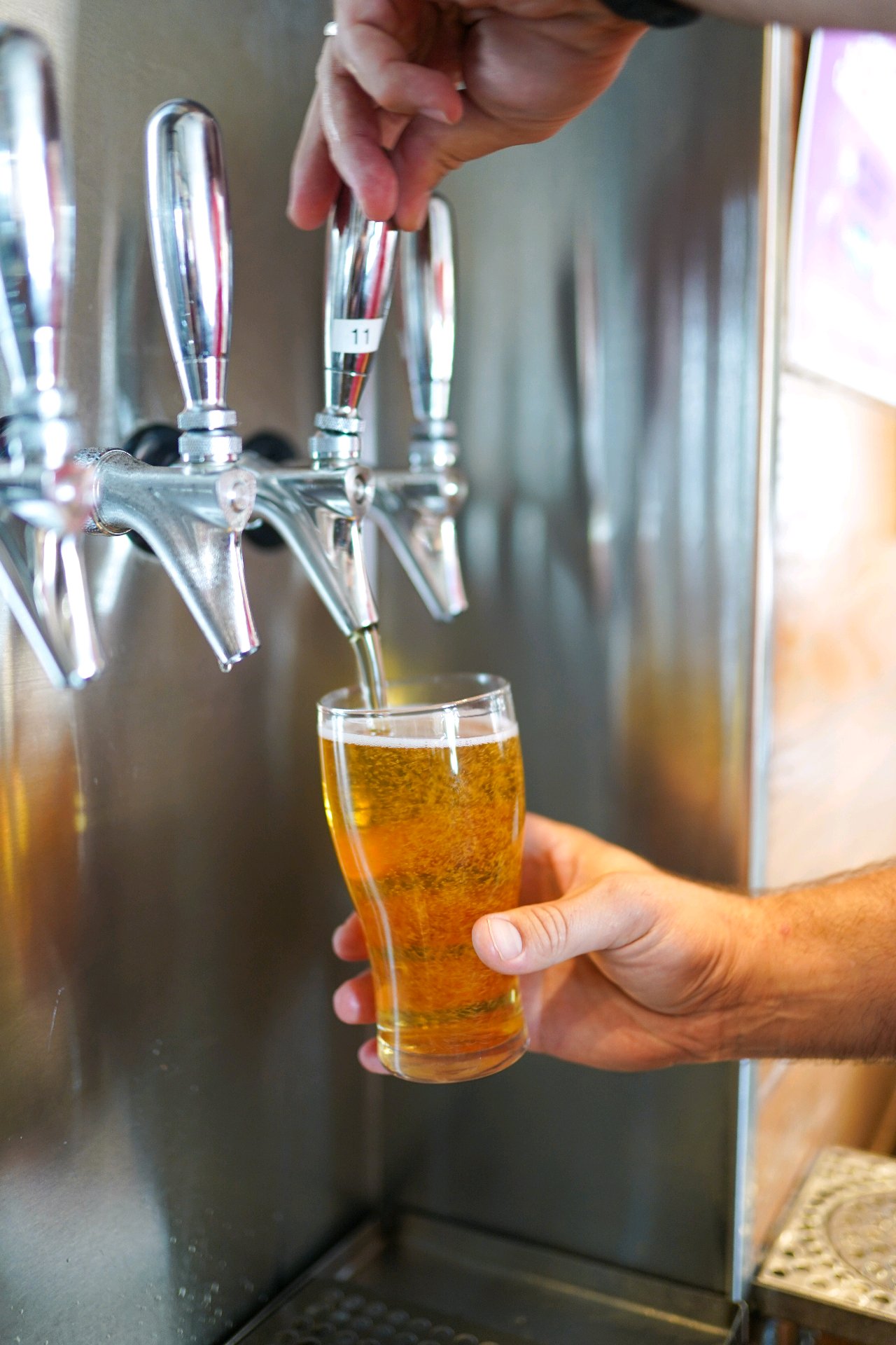 A pint being poured from the Grand Strand Brewing Company tap wall