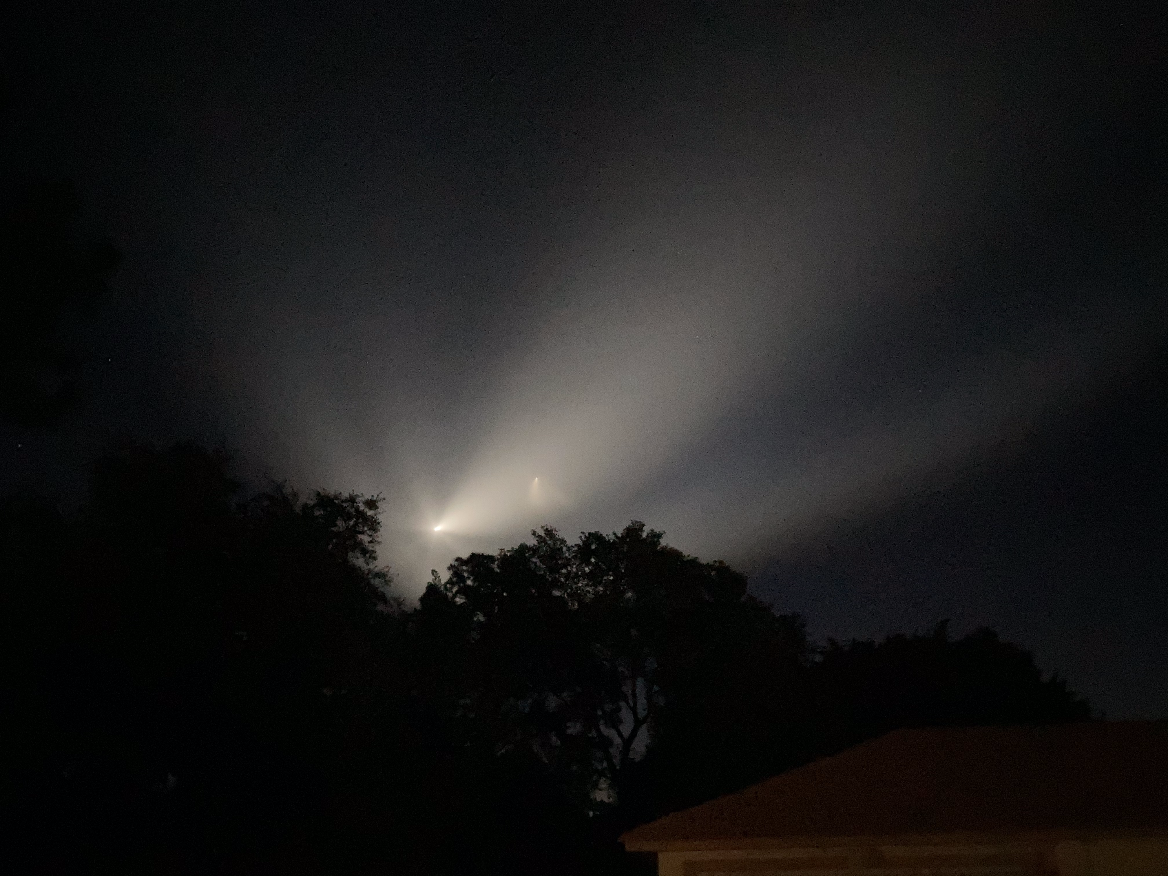 The Crew-2 launch plume drawn in glowing spirals at night