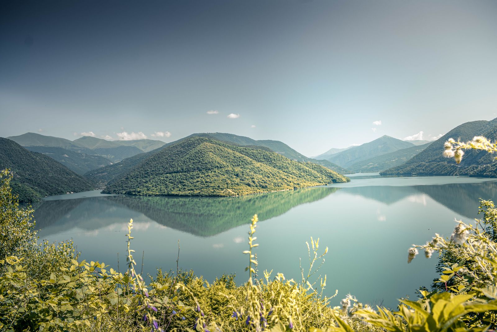 A mountain lake surrounded by forested ridges