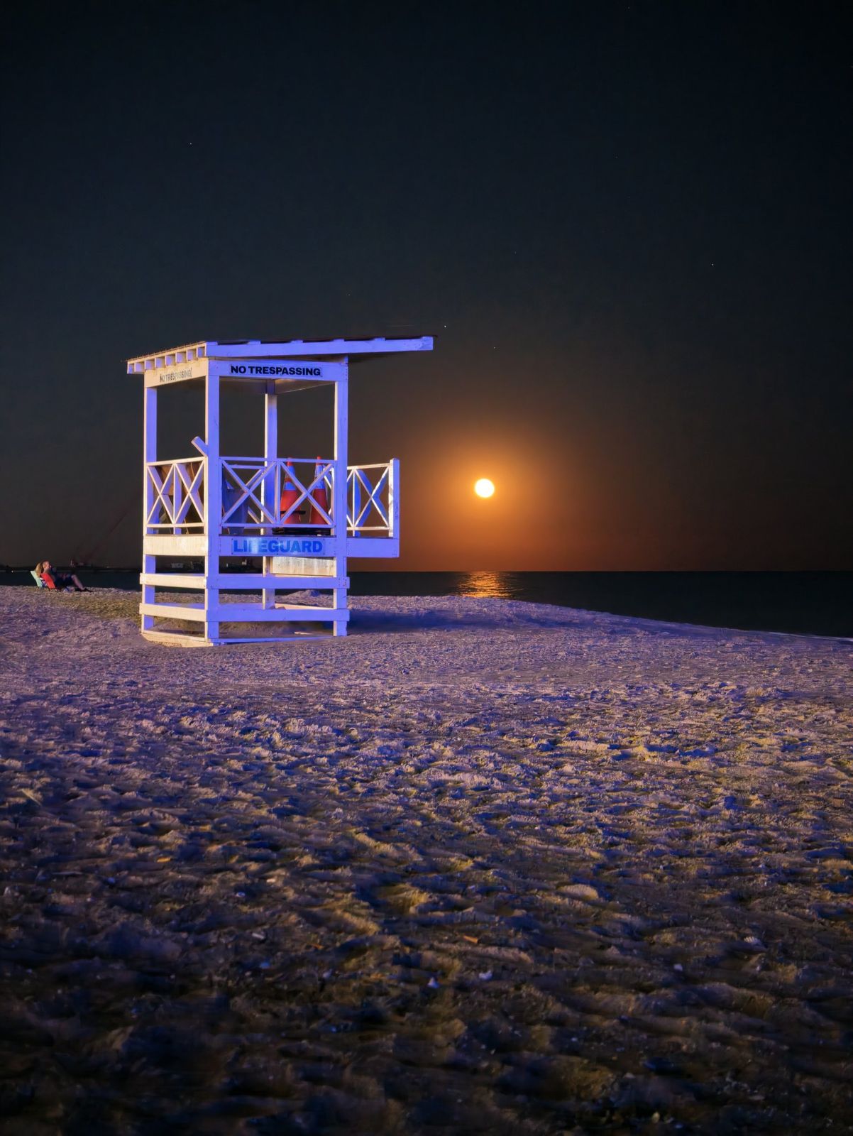 Empty lifeguard stand at moonrise