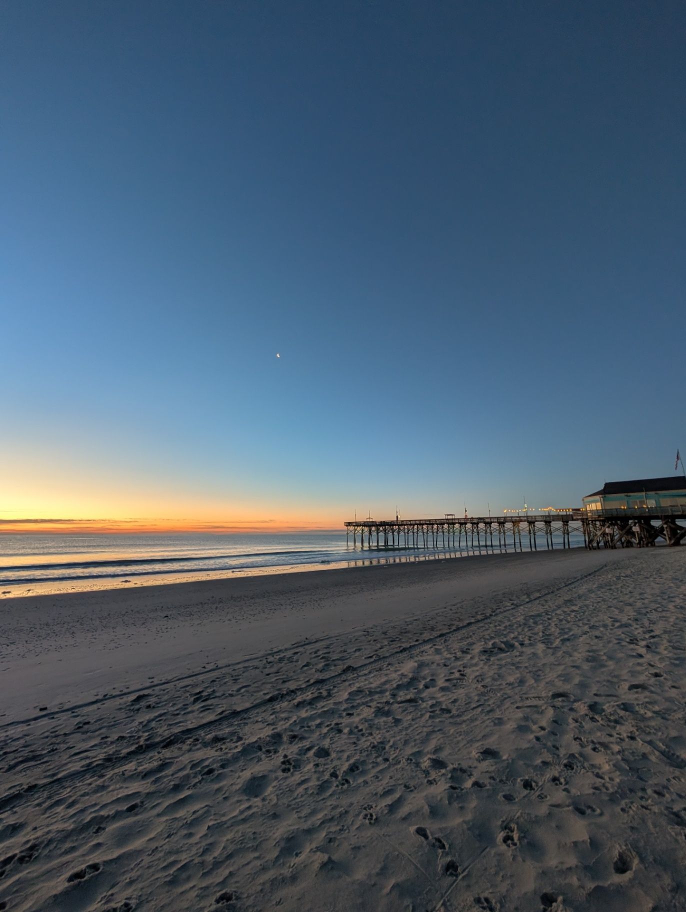 User-owned photo of a beach and pier at sunrise